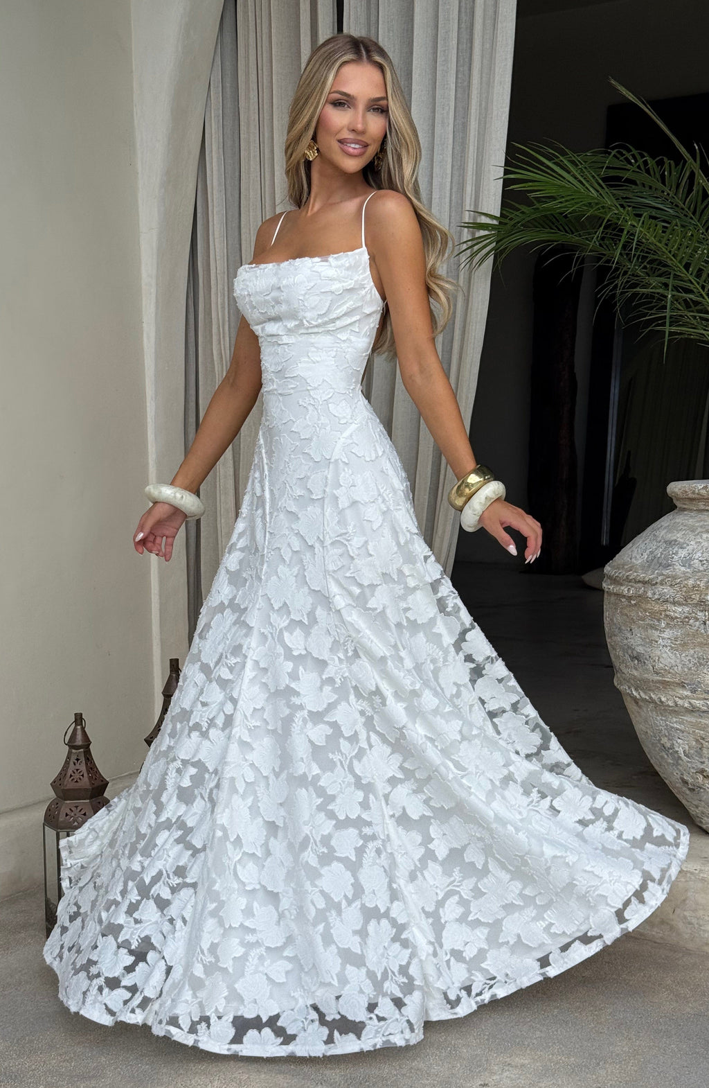 Ladies' maxi dress with waterfall neckline, spaghetti straps, floral pattern, and lace-up back