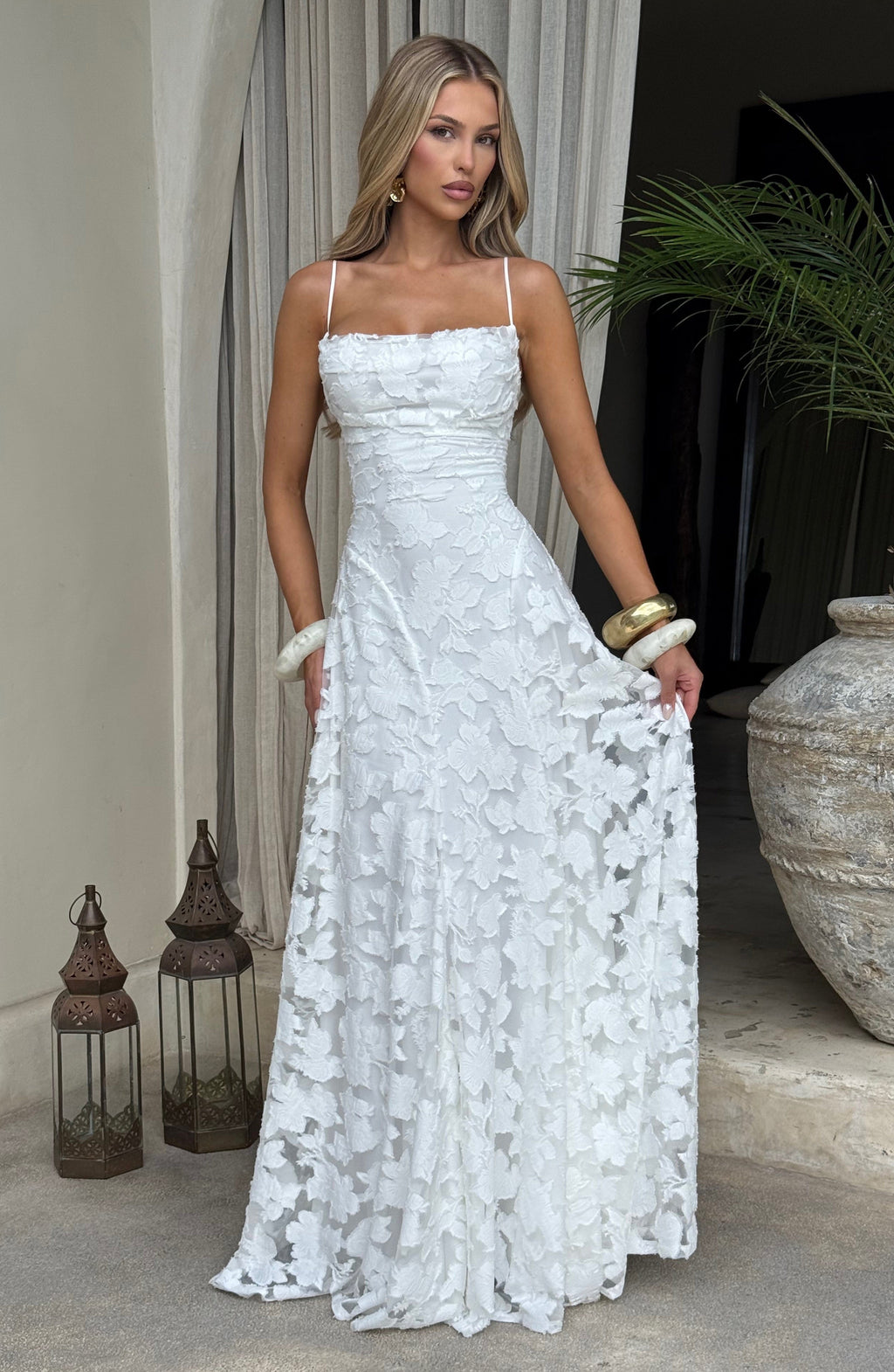 Ladies' maxi dress with waterfall neckline, spaghetti straps, floral pattern, and lace-up back